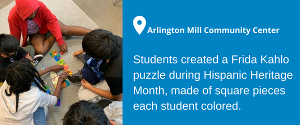 A photo of children working on a colorful puzzle at the Arlington Mill Community Center. Students created a Frida Kahlo puzzle during Hispanic Heritage Month, made of square pieces each student colored.